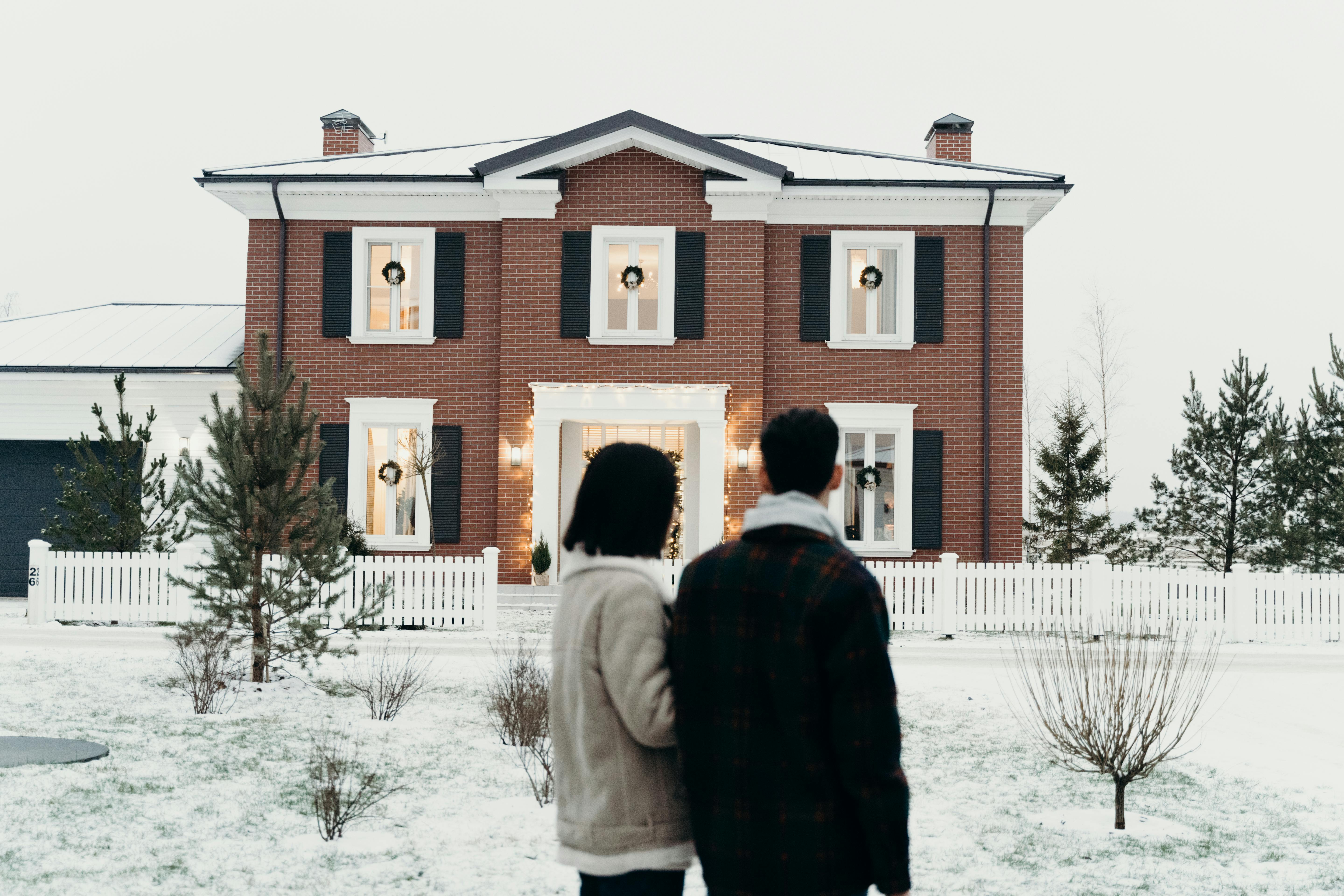 Couple from behind looking at a house